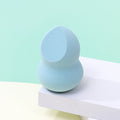 Cut a beauty sponge puff in half; it won't absorb powder and will be shaped like a gourd