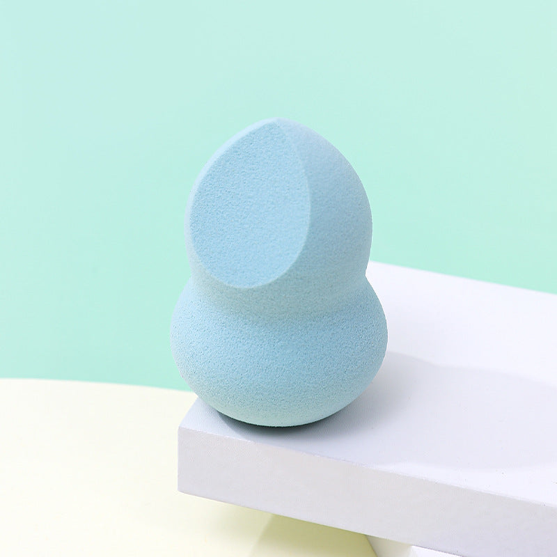 Cut a beauty sponge puff in half; it won't absorb powder and will be shaped like a gourd