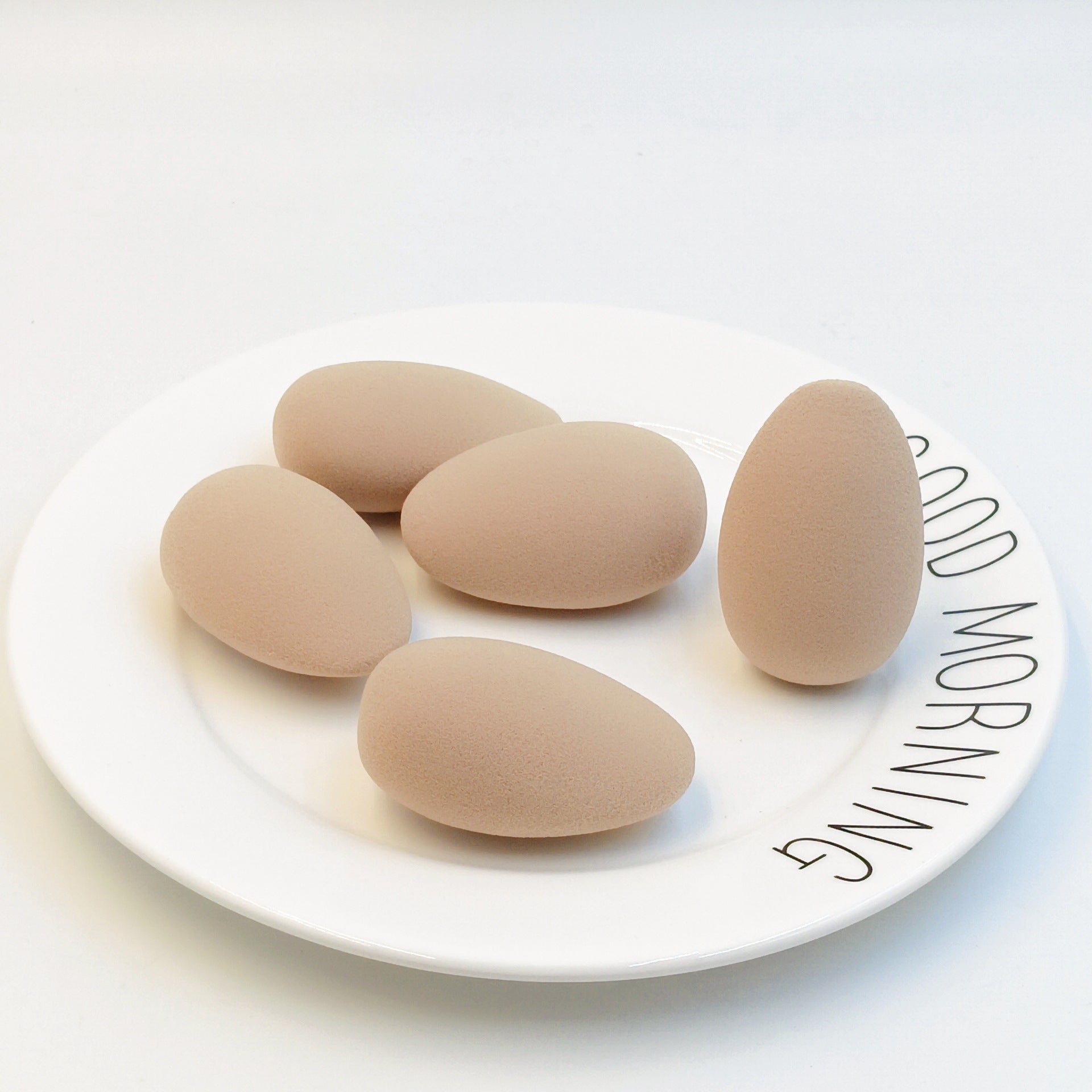 Oval-shaped makeup sponge that expands when soaked in water