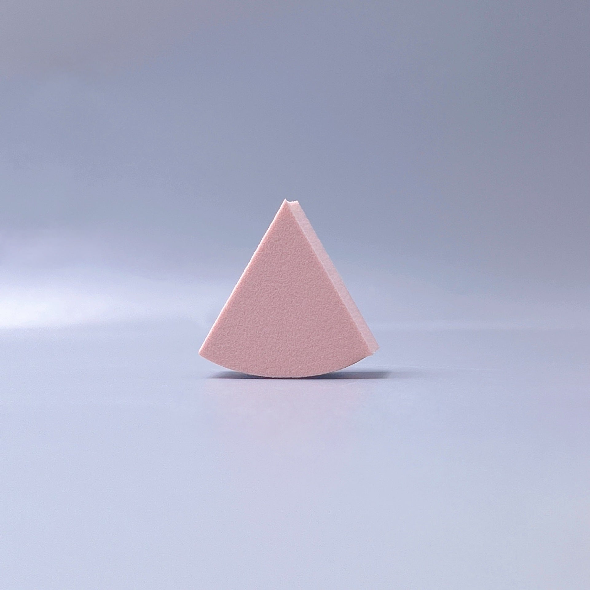 Fan-shaped powder puff, usable wet or dry, expands when wet for a makeup sponge